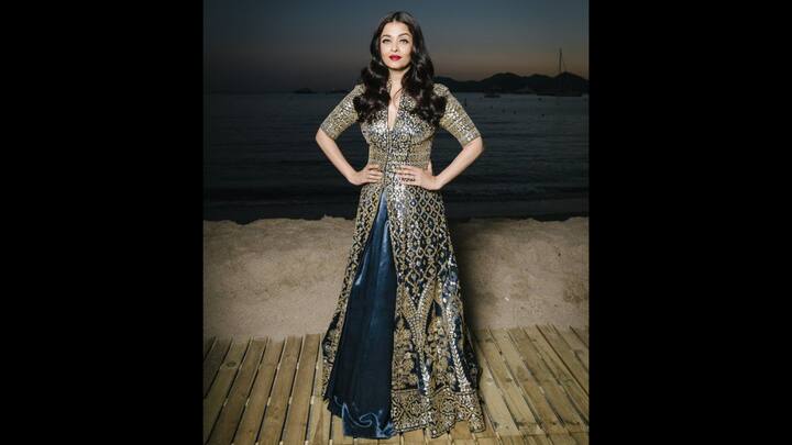 1. Aishwarya Rai: Aishwarya Rai wore a luxurious Anarkali gown that consisted of traditional golden embroidery. The jacket style silhouette along with the gold detailing added richness to the outfit. The graceful flare is ideal for statement festive dressing. (Image Source: Pinterest/KickassUnicorn)