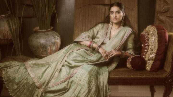 Sonam Kapoor stunned in this saree-styled lehenga adorned with intricate embroidery and embellishments. She looked effortlessly regal in a V-neck jacket blouse, pleated skirt, and draped dupatta. (Image Source: Instagram/ sonamkapoor)