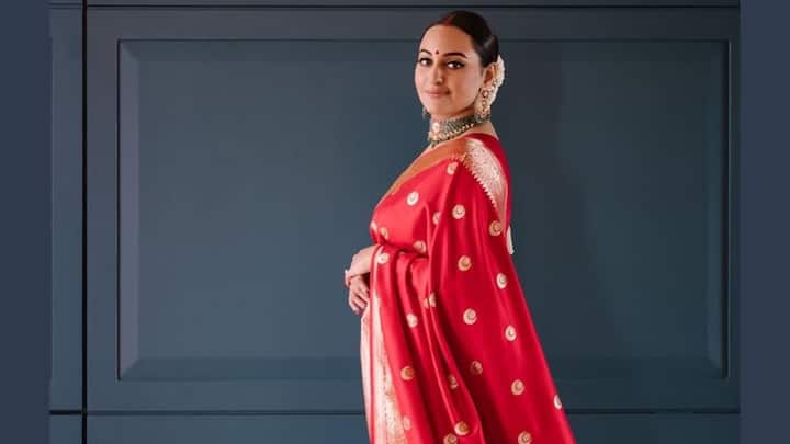 Sonakshi Sinha wore this red Banarasi saree with a golden border that looks regal. She accessorised it with emerald and kundan jewellery, a sleek bun with white flowers, and traditional red bangles, making it a perfect choice for Ram Navami puja. (Image Source: Instagram/ aslisona)