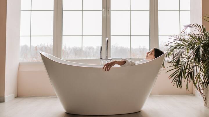 1. Take A Long Bath: A warm, long, and relaxing bath and soothe your mind as well as your body. Add Epsom salt, essential oils, or a bath bomb into your bathing water for extra indulgence. The water will ease your muscle tension and release stress. It will lead you to feel fresh and rejuvenated. (Image Source: Canva)