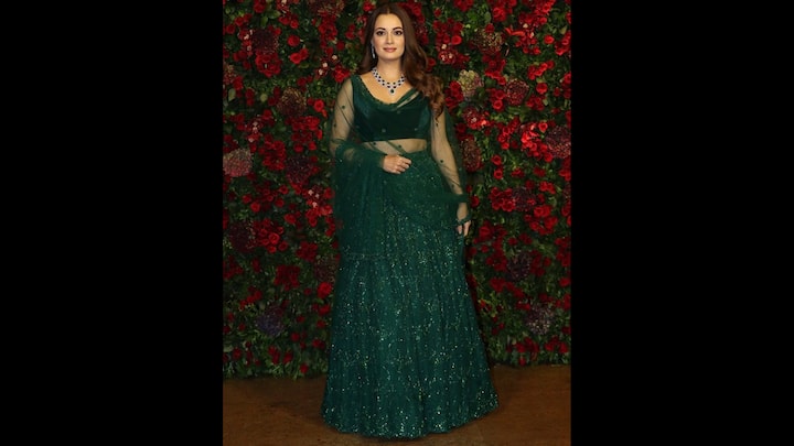 1. Dia Mirza: Dia Mirza wore a dazzling emerald green lehenga with a shimmering detailing. Her outfit featured a sleeveless blouse, embellished lehenga, and a sheer net dupatta. She completed her look with matching emerald green and silver jewellery that exuded elegance, making the attire ideal for Navratri celebrations. (Image Source: Pinterest/vogueindia)