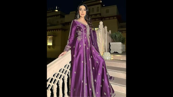 4. Karisma Kapoor: Karisma Kapoor wore a stunning purple full sleeve kurta that was adorned with intricate golden embroidery. The regal fabric exuded elegance. Her floor length and flared kurta had a middle slit, giving the outfit a modern touch. She paired her look with matching trousers and statement earrings which made the fit ideal for festive celebrations. (Image Source: Pinterest/wishnwed)
