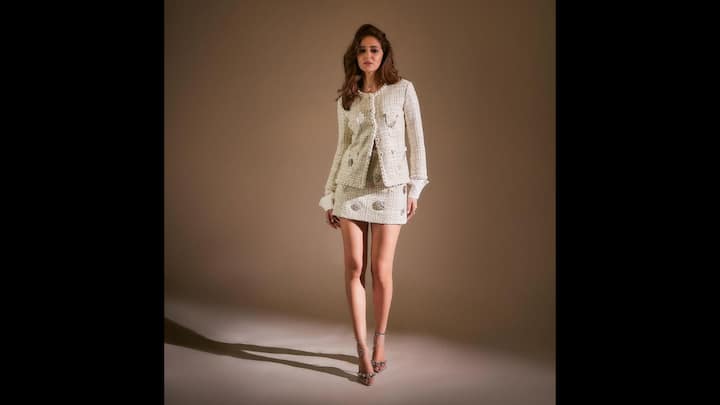 8. Chic Classic Tweed Attire: Ananya Panday wore a structured ivory tweed co-ord set that consisted of a mini skirt and matching blazer. The outfit was embellished with sparkles that enhanced her look. She wore matching strappy heels to complete her outfit which added a modern twist. (Image Source: Instagram/@ananyapanday)