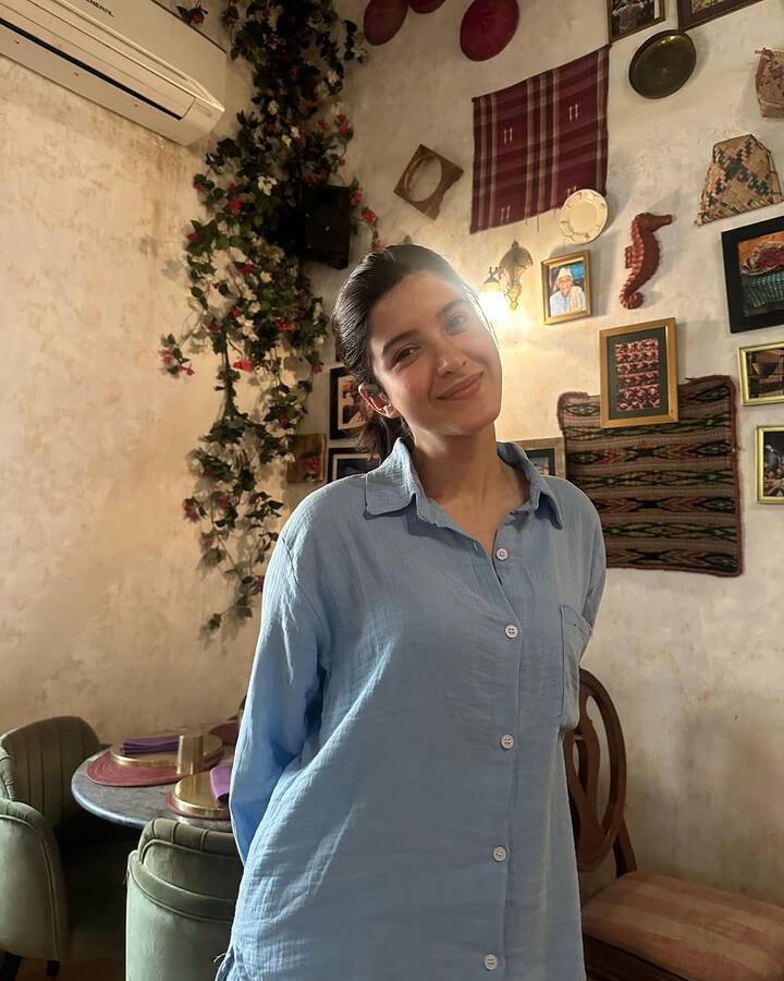 Another picture features Shanaya flashing her charming smile while wearing a blue oversized cotton shirt.