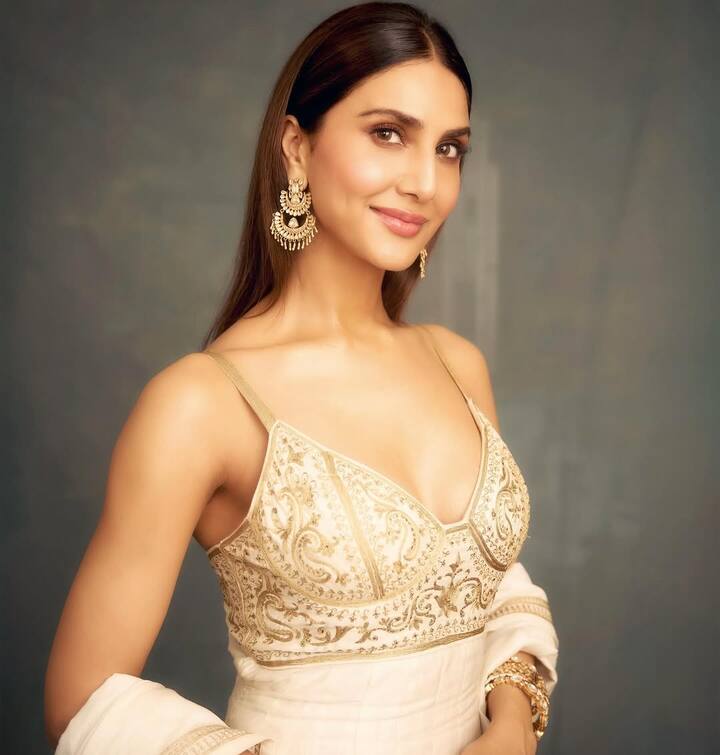 Vaani accessorized with gold chaand earrings and a cuff bracelet, enhancing the dreamy vibe of her outfit.