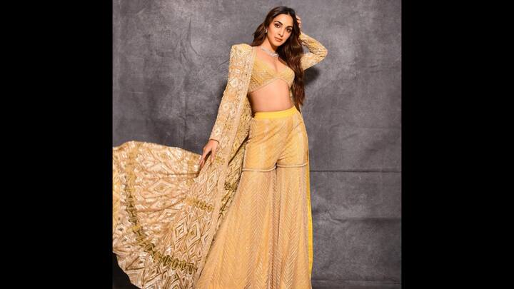 5. Kiara Advani: Kiara Advani wore a vibrant yellow three piece traditional outfit that can brighten up any special occasion. Her outfit featured a long and flowing jacket, bralette blouse, and flared palazzos. The intricate detailing on the outfit added a regal touch that made it perfect for traditional puja ceremonies. (Image Source: Instagram/@kiaraaliaadvani)