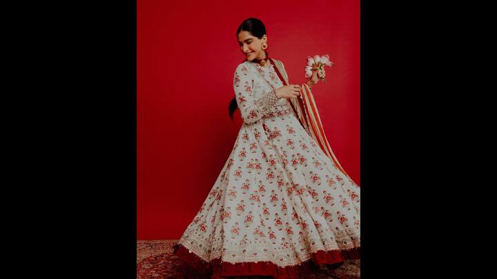 2. Sonam Kapoor: Sonam Kapoor's floral Anarkali radiated a classic elegance. The while flowy Anarkali featured bright red floral patterns all over it with red tassel and border detailing at the hem. The actress paired her look with a striped dupatta and matching gold and red jewellery. (Image Source: Instagram/@sonamkapoor)