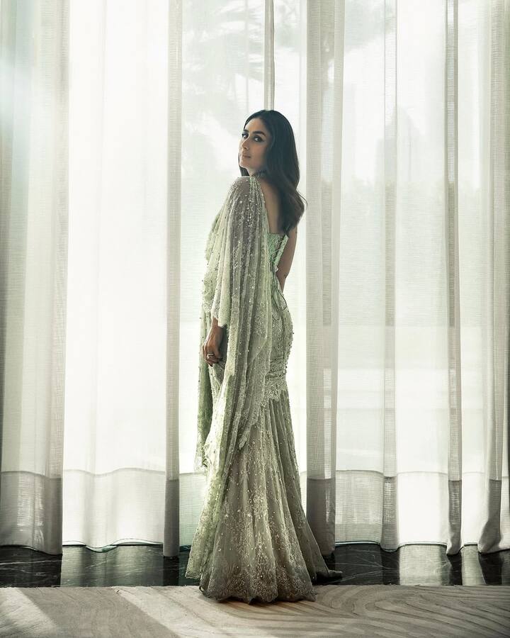 The intricately hand-embellished outfit, featuring shimmering sequins and fine lace details, perfectly hugged her silhouette while maintaining a soft, romantic vibe. The draped dupatta, adorned with light beadwork and lace borders, added a vintage charm to the contemporary cut of her attire.