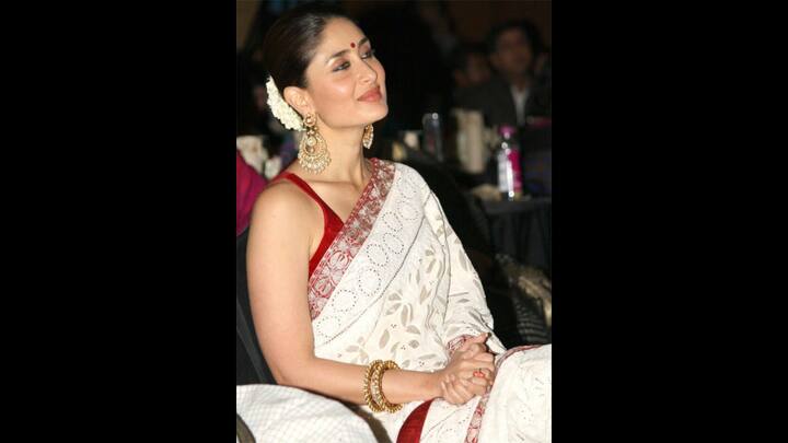 2. Kareena Kapoor: Kareena Kapoor slayed her red and white saree look. The saree had floral patterns and a bold red border with intricate gold embroidery. She styled her look with gajra, statement earrings, and classic red bindi for a traditional charm. (Image Source: Pinterest/sarwatj)