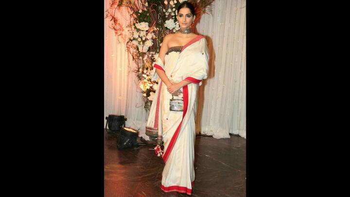 8. Sonam Kapoor: Sonam stunned in a contemporary red and white saree. Her saree had small and intricate patterns. The actress paired her look with a silver choker necklace and matching handbag. She seamlessly blended tradition with high fashion that made her attire perfect to wear on Pohela Boishakh. (Image Source: Pinterest/kamalshikder)