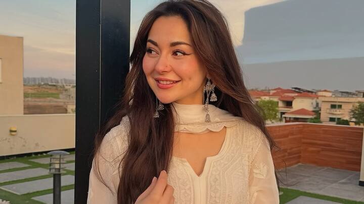 Hania Aamir is breathtaking in this floor-length white chikankari kurta featuring sheer and floral threadwork. With matching pants, dupatta, and oxidised earrings, this look is perfect for a daytime traditional gathering.  (Image Source: Instagram/ haniaheheofficial)