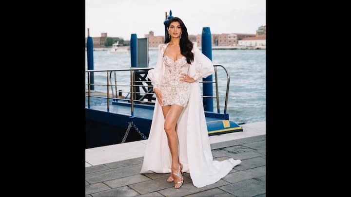 8. White Regal Look: Jacqueline Fernandez wore a body hugging white mini dress that she paired with a dramatic white cape. The cape had puffed sleeves and delicate embroidery that elevated the look. The actress's breathtaking look was complemented by stunning diamond jewellery and beautiful heels. (Image Source: Instagram/@jacquelienefernandez)
