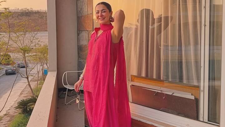 Hania's pink Chikankari suit is gorgeous with its heavy work on the fabric and matching dupatta. Pink jhumkas and soft dewy makeup complement the suit, making it an elegant choice for any traditional affair. (Image Source: Instagram/ haniaheheofficial)