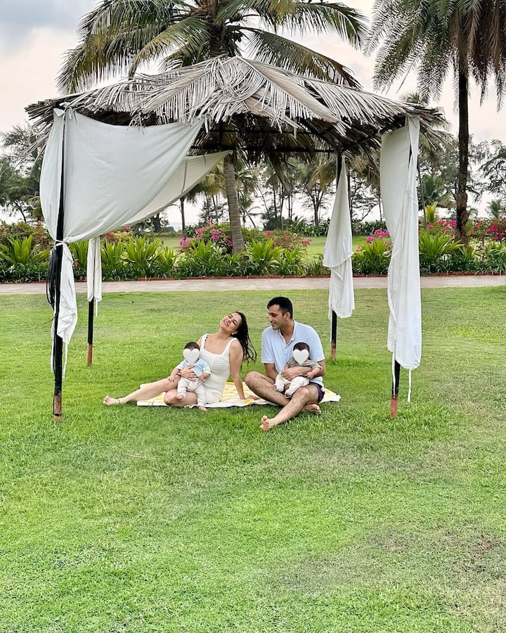 Taking to Instagram, Shraddha posted a series of photos featuring her, Rahul, and their twins enjoying some sunshine. In the first image, the couple is seen sitting under a hut, each holding one of their babies.
