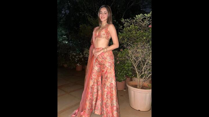 5. Floral Palazzo Set: Ananya Panday radiated charm in a vibrant floral palazzo set that featured a matching blouse and dupatta. The backless blouse had a plunging neckline and was adorned with mirror embellishments. The peach hues and matching gold jewellery created a festive vibe that's ideal for modern celebrations. (Image Source: Instagram/@ananyapanday)