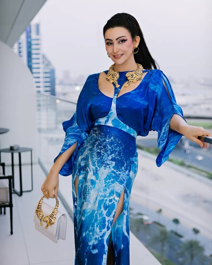 Her standout accessory? A white mini handbag with sculpted tiger handles in gold—equal parts fierce and fabulous. The tiger motif brought a wild, untamed energy to the look, staying true to Cavalli’s signature aesthetic.