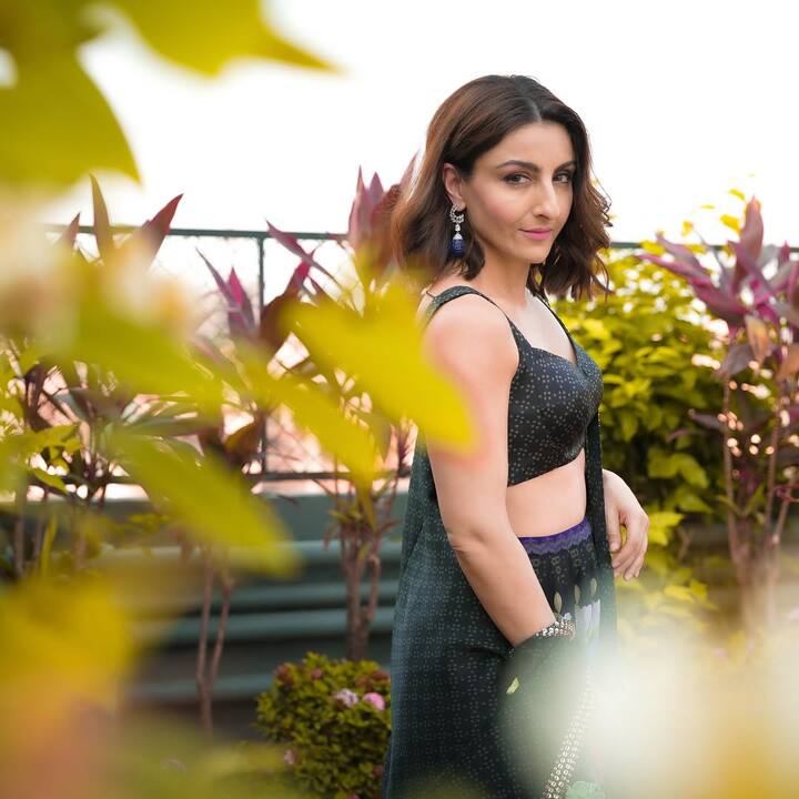 Her hair was styled into soft, tousled waves that framed her face naturally. The shoulder-length cut enhanced the relaxed yet sophisticated vibe of her entire appearance, keeping the focus on her delicate features and the intricate detailing of her outfit.