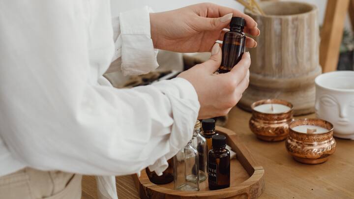 7. Aromatherapy: Essential oils like lavender, sandalwood, bergamot, and eucalyptus, and more can efficiently reduce anxiety. You can diffuse these oils in the morning or use them in shower to create a calm atmosphere. These essential oils are known to promote relaxation naturally. (Image Source: Canva)
