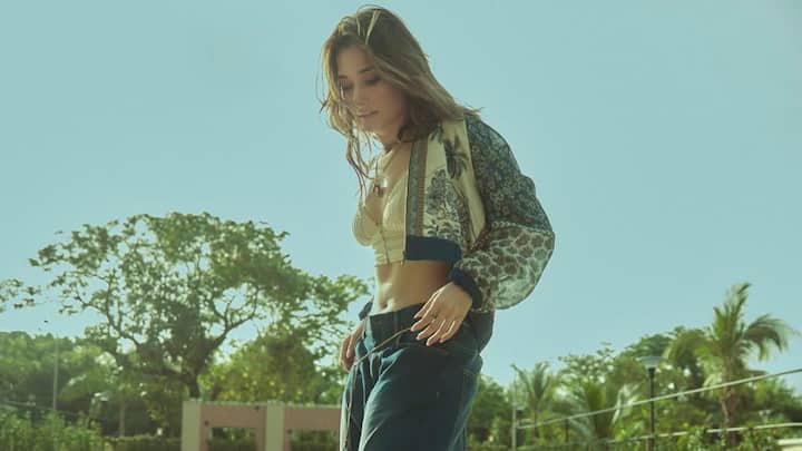 The white bralette paired with a floral crop shrug atop ripped wide-leg jeans gives Tamannah the ideal casual look one would wear on any scorching summer day. It allows the relaxed flow and combing with denim to keep things chill and effortlessly chic. (Image Source: Instagram/ tamannaahspeaks)