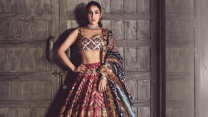 Sara Ali Khan enthralled the viewers in her bright red printed lehenga with flowers and elephant motifs that stand out like palace wall art. With sequins, mirrors, and Resham work, the dress was made more beautiful with its famous attachment: the pink choli and blue dupatta. (Image Source: Instagram/ saraalikhan95)