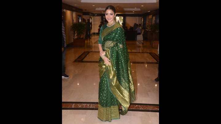 1. Traditional Green Saree: Anusha Sharma's green silk saree have a golden zari work which gave her a unique look. She complemented her saree with a matching blouse and traditional jewellery. The timeless and graceful added sophistication to her look, making it ideal for festive or formal celebrations. (Image Source: Pinterest/vogueindia)
