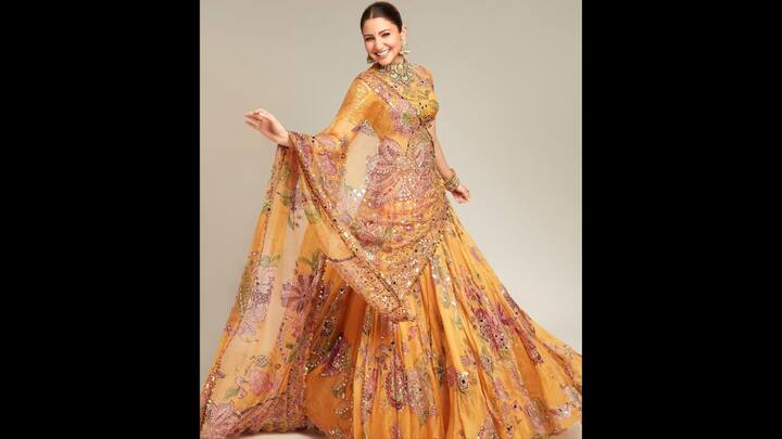 3. Yellow Embellished Lehenga: Anushka Sharma dazzled in a yellow lehenga that had intricate floral embroidery and mirror work. The fabric had a regal appeal to it that made it ideal for festivities. She paired her lehenga with a flowing dupatta. The actress completed her outfit with heavy traditional jewellery to enhance her look. (Image Source: Pinterest/boseindrani78)