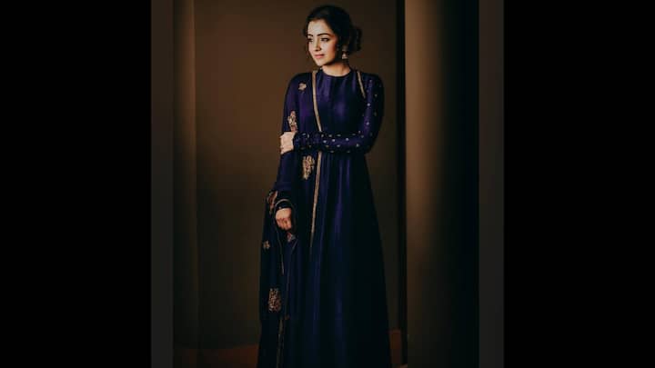 1. Blue Anarkali: Trisha Krishnan wore a floor length blue Anarkali with delicate golden embroidery that made her look stunning. Her full sleeved outfit was paired with a graceful matching dupatta. For a traditional look, she wore golden accessories that elevated her style. (Image Source: Instagram/@trishakrishnan)