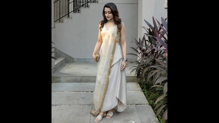 8. Minimal Glam: Trishna Krishnan opted for an ivory fushion drape outfit that blended a contemporary silhouette with traditional grace. Her net dupatta had a gold detailed all across the borders and the statement chocker necklace added sparkle with a pop of colour to her fit, elevating the understated glamour. (Image Source: Instagram/@trishakrishnan)