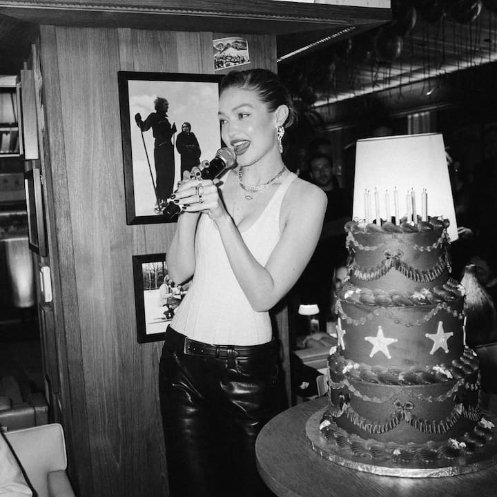 In the photo, Gigi and the 50-year-old Maestro actor share a kiss in front of her towering three-tier chocolate birthday cake. Dressed in a white top with her hair styled in a sleek bun, Hadid is seen cupping Cooper’s face affectionately.
