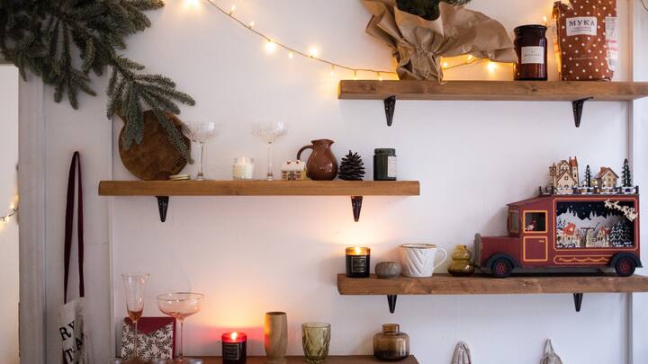 Go Vertical: Use your wall height wisely — tall storage units, wall-mounted shelves, and lofts keep things off the floor and give rooms a lighter, more open feel. (Image Source: Canva)