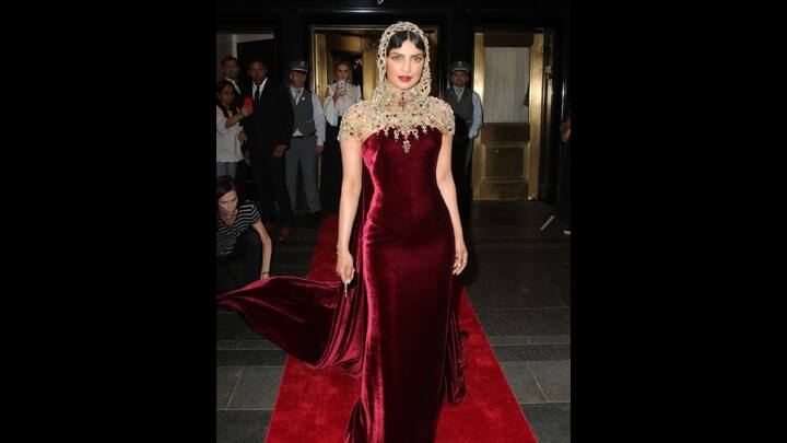 5. Priyanka Chopra: Priyanka Chopra graced the Met Gala in a regal maroon and gold ensemble in 2018. The outfit, designed by Ralph Lauren, was richly adorned with beadwork and Swarovski crystals. The gown that shimmered with opulence was embroidered in India. Priyanka's look was elevated with a striking gold beaded hood that blended cultural craftsmanship with high fashion. (Image Source: Instagram/@t2telegraph)