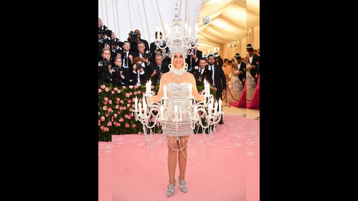 5. Katy Perry: Kerry Perry lit up the Met Gala by walking onto the red carpet as a life sized chandelier. Designed by Jeremy Scott, the dazzling creation featured glowing lights and layers of ornate detailing. It has been revealed that the designer's team had placed thousands of Swarovski crystals before attaching real chandelier elements. This statement look of Katy Perry turned her into a walking glamour. (Image Source: Instagram/@justjared)