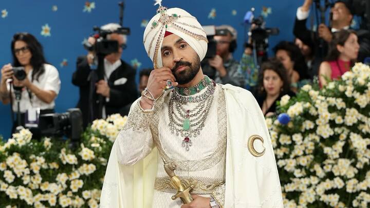 Diljit Dosanjh in Prabal Gurung: Diljit Dosanjh had Punjabi royalty in all white by Prabal Gurung, complete with a turban, a cape embedded with Punjabi script, and a sword. The look was a beautiful amalgamation of tradition and luxe. (Image Source: Instagram/ diljitdosanjh)