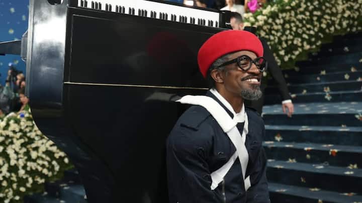 André 3000 in Burberry: André 3000 had a bold comeback, dressed in Burberry and carrying a Pink Sparrow Steinway baby grand piano backpack, the latter being an artistic reference to his new EP, 7 Piano Sketches. The look was a seamless mixture of high fashion and performance art. (Image Source: Instagram/ instylemagazine)