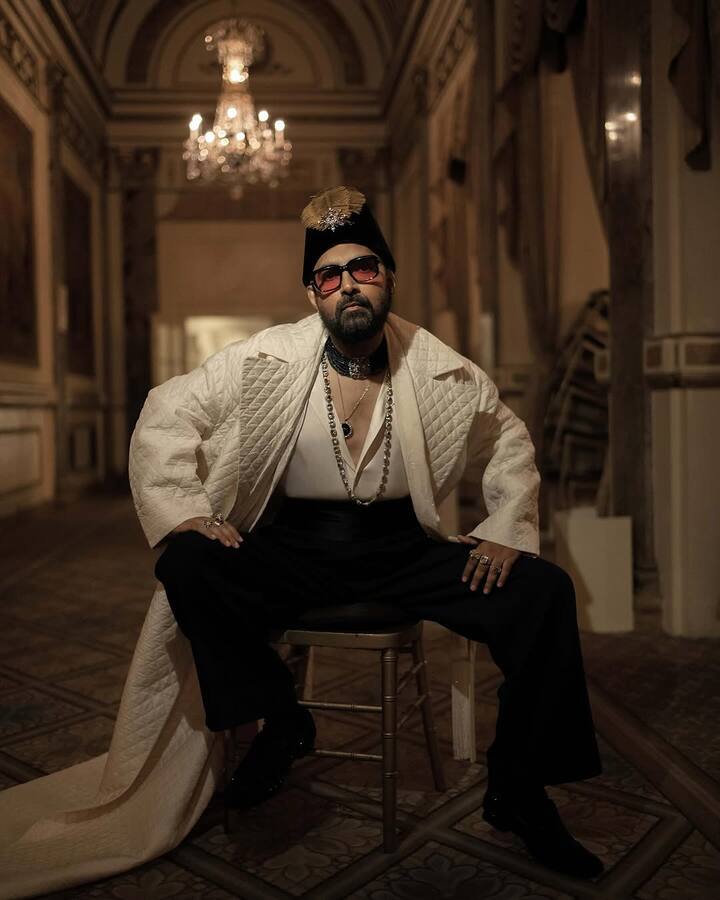Designer Sabyasachi also walked the red carpet in a quilted ivory overcoat, jewelled velvet cap, and layered royal accessories. (Instagram/sabyasachiofficial)