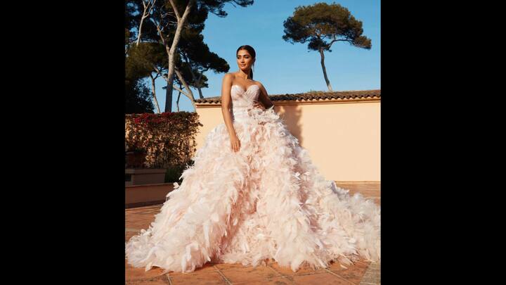 2. Ethereal Feathered Gown: Pooja Hegde radiated a fairy charm in a blush pink feathered ball gown. Her outfit featured a strapless, sweetheart neckline that gave her the perfect red carpet look. The voluminous gown's soft feather detailing created a dreamy couture look. (Image Source: Instagram/@hegdepooja)