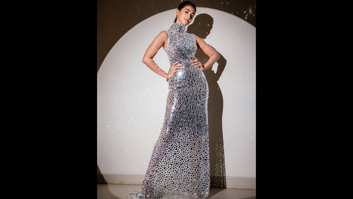 6. Dazzling Mirror Gown: Pooja Hegde turned heads in her sleeveless, high neck gown that was embellished with mirror work. The body hugging ensemble gave a shimmering mosaic effect that made the actress look glamorous. Her outfit was perfect as a bold red carpet statement.  (Image Source: Instagram/@hegdepooja)