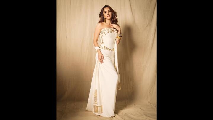 3. Regal White Elegance: The strapless white outfit of Kiara Advani had delicate golden embroidery over it. The sleek ensemble was paired with stunning golden earrings and a touch of ethnic charm that created a perfect fusion of tradition and modernity. (Image Source: Instagram/@kiaraaliaadvani)