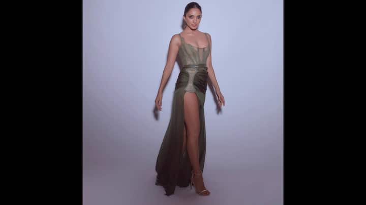 7. Olive Green Look: The daring olive green gown worn by Kiara Advani featured a sheer corset bodice and a bold thigh high slit. The flowy fabric and lace detailing of the outfit highlighted the actress's toned frame. The actress opted to paired her Western look with minimal and delicate jewellery and high heels. (Image Source: Instagram/@kiaraaliaadvani)