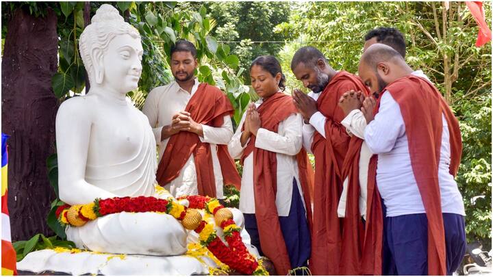 Devotees prayed and offered flowers at the statue of Lord Buddha in Bengaluru. (Image Source: PTI)