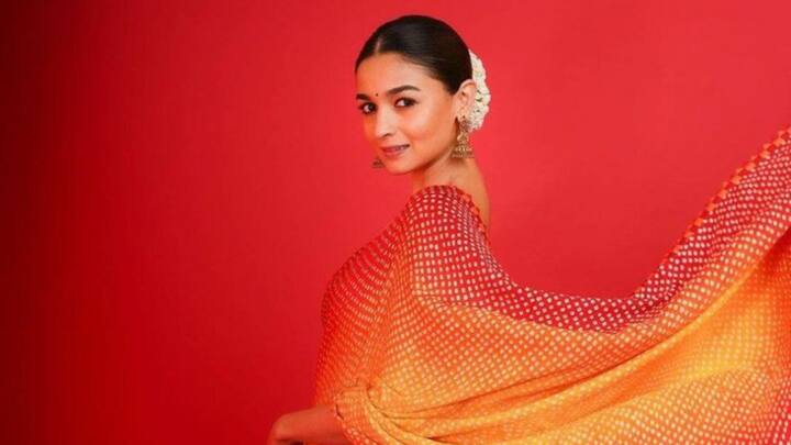Alia Bhatt looked mesmerising in this red and yellow ombre Bandhani saree. Traditional and simple look with her sleek bun adorned with gajra, jhumkas, and soft make-up with a bindi. (Image Source: Instagram/ stylebyami)