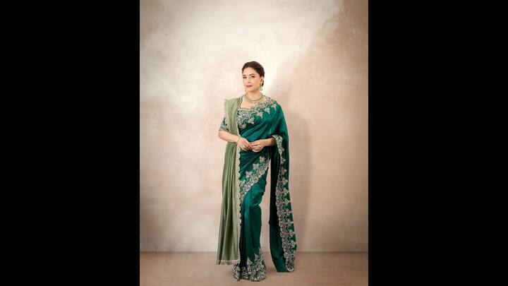 1. Regal Emerald Saree: Madhuri Dixit exuded timeless grace in an emerald saree which had intricate silver embroidery. She paired her ethnic outfit with a matching blouse and delicate jewellery. The traditional outfit gave her a glamorous and sophisticated look. (Image Source: Instagram/@madhuridixitnene)