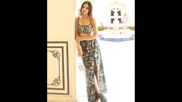 4. Fusion Look: Nitanshi Goel channeled modern day royalty with a bohemian twist with this outfit. She wore a crop top with a high-slit skirt that was adorned with intricate floral prints. The outfit gave a relaxed vibe and a chic appeal. She elevated her look with accessories like layered gold necklaces, chunky bangles, bracelet, and a small statement bag. The actress added an Indian touch to the contemporary silhouette with her outfit. (Image Source: Instagram/@nitanshigoelofficial)