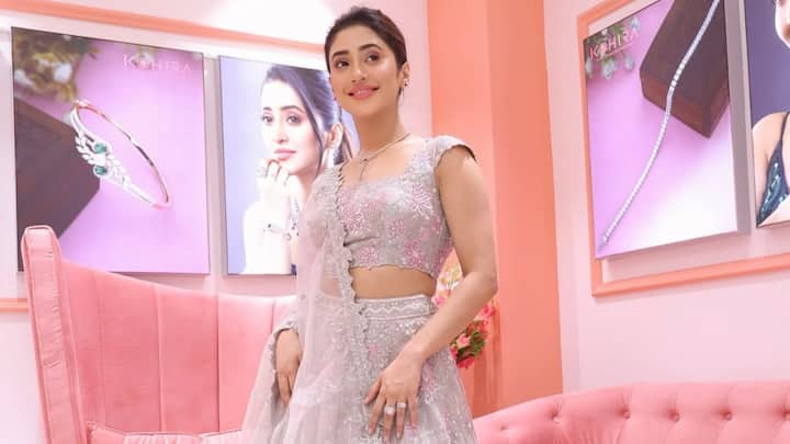 Shivangi looks ethereal in this grey lehenga with floral designs and a scalloped round-neck blouse. The delicate detailing and minimal styling result in a classic and royal look. (Image Source: Instagram/ shivangijoshi18)