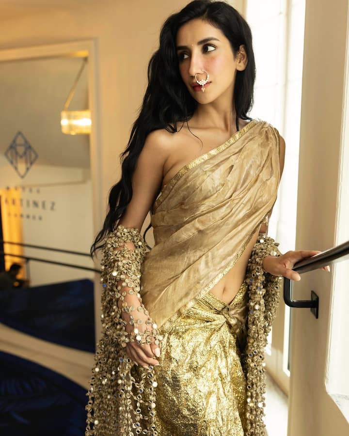 Parul further wrote- 'This custom Banarasi tissue sari made by Mohit Rai and team is immersed in raisins, painted on my body and coined like other skin, traditional cloth, futures finish and a couture moment, very desi.'