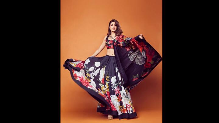 1. Floral Lehenga: Jacqueline stunned in a vibrant lehenga that had bold floral prints of yellow, pink, orange, white, and more. She wore a matching blouse and a flowing dupatta that enhanced the ethnic look's grace. The lightweight lehenga created a striking look and the prints gave it a modern flair. The actress paired her dark coloured lehenga with oxidised silver jewellery that added tradition to her fit. (Image Source: Instagram/@jacquelienefernandez)