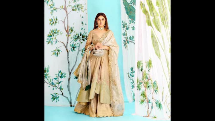 6. Soft Gold Sharara Look: Genelia D'Souza blended delicate detailing with understated glamour when she adorned her ensemble. The outfit featured an embellished blouse with sequin and threadwork. Each layer of her attire added texture to the look. The sheer dupatta with scalloped borders and gold motifs gave a gorgeous aura while effortlessly completing her look. For the final touch, she added a choker and earrings that gave her a youthful vibe. (Image Source: Instagram/@geneliad)