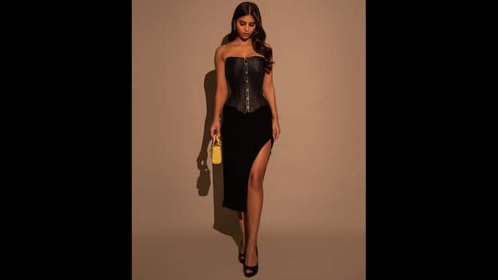 2. Elegant Corset Look: Suhana Khan served a fierce and elegant look in her black strapless corset top that she paired with a thigh-high slit skirt. To add a touch of colour, she added a mini yellow handbag to her look which made a playful contrast, ideal for a Gen Z night-out. The actress perfectly captured the trendy and fearless fashion statement with her look. (Image Source: Instagram/@suhanakhan2)