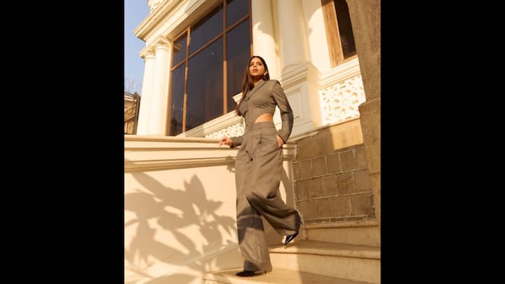6. Business Chic In Cut-Out Suit: Suhana Khan redefined business chic with her modern take on the classic pantsuit. She wore a structured co-ord set that blended sophistication with youthful edginess. The outfit featured a tailored blazer-style crop top that had dramatic cut outs for a bold Gen Z look. She paired her blazer with wide-leg trousers and black heels. (Image Source: Instagram/@suhanakhan2)