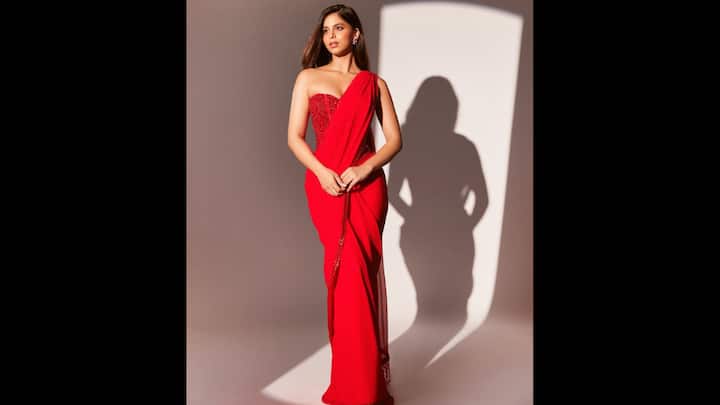 8. Contemporary Saree Look: Suhana Khan redefined the traditional elegance with a bold Gen Z twist in her striking red saree. The saree was paired with a corset-style blouse that merged the Indian attire with a high fashion silhouette. The elegant hue of the outfit reflected youthfulness and minimalism. The strapless and embellished corset-style blouse served as the highlight of the whole outfit and paired it with minimal matching jewellery. (Image Source: Instagram/@suhanakhan2)